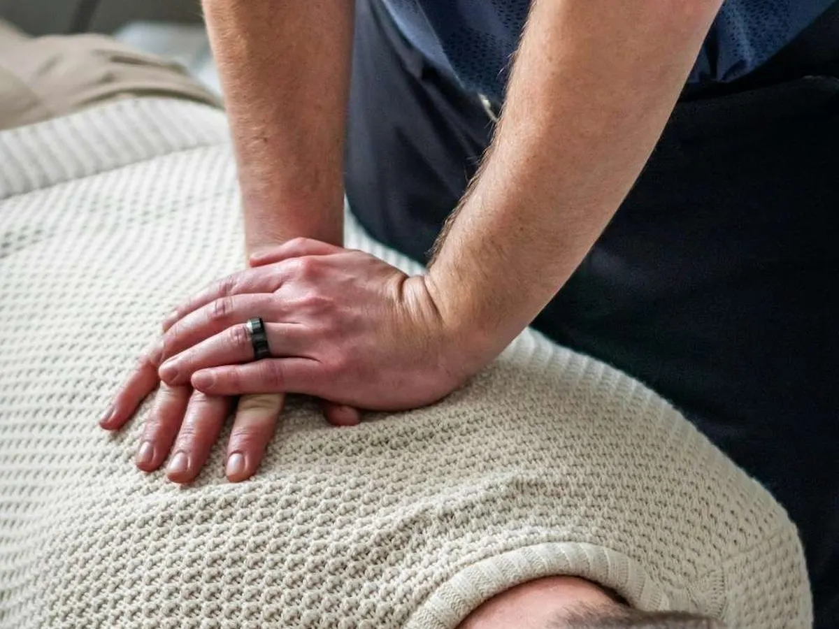 Chiropractor adjusting a patient's upper back