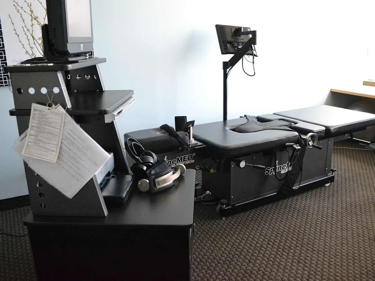 Computer-controlled spinal decompression table in a treatment room